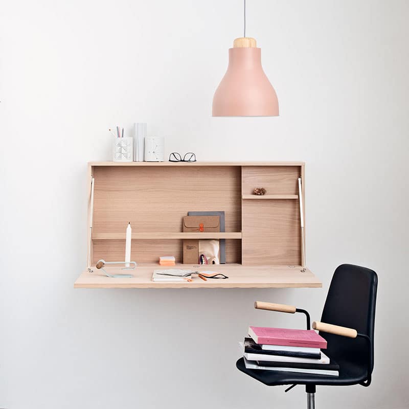Minimalist workspace with desk, chair, and lamp.