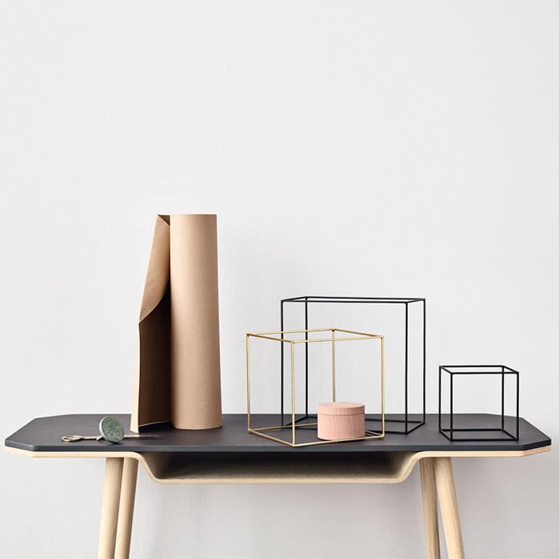 Minimalist table with geometric decor items.