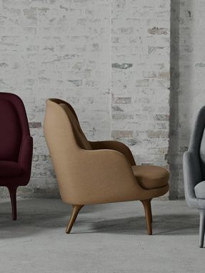 Modern armchairs against a brick wall background.
