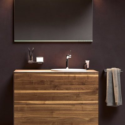 Modern bathroom vanity with wooden cabinet.