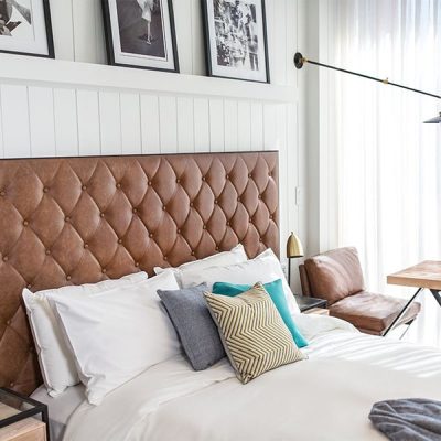 Stylish bedroom with pillows and wall art.