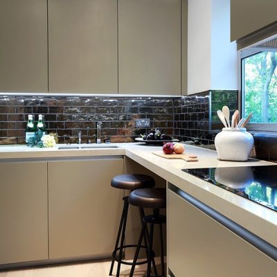 Modern kitchen with sleek cabinets and utensils.