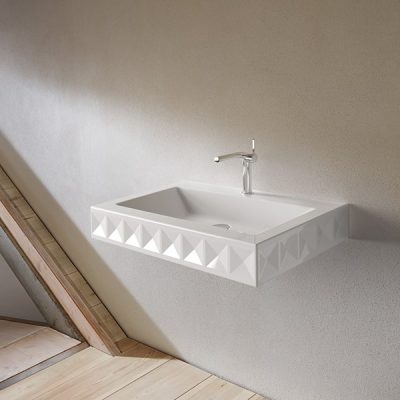 Modern geometric sink with wall-mounted faucet.