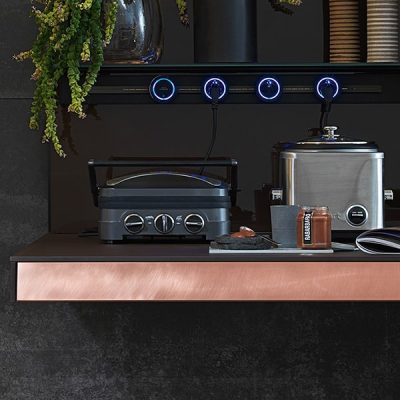 Kitchen counter with appliances and plants.