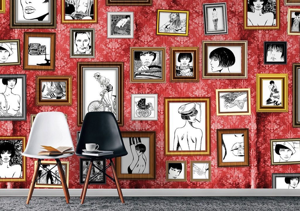 Chairs against red wall with framed illustrations.