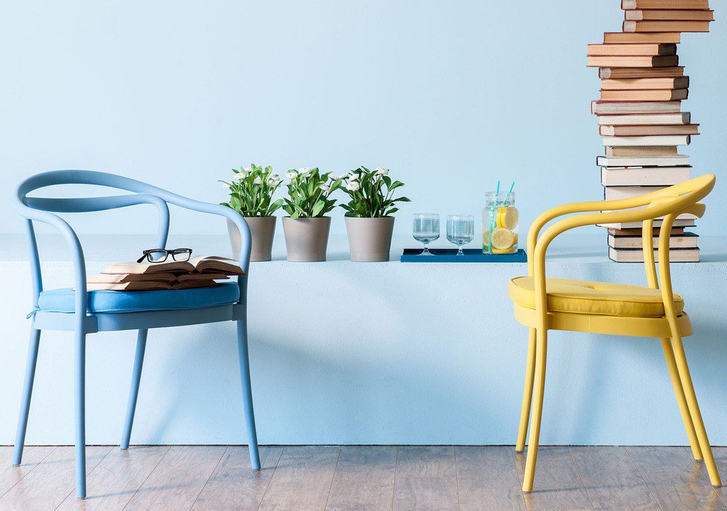 Two chairs, books, plants, and drinks.