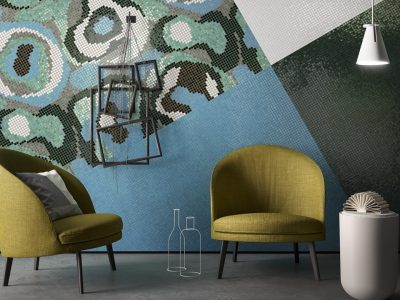 Two green chairs, abstract mosaic wall design.
