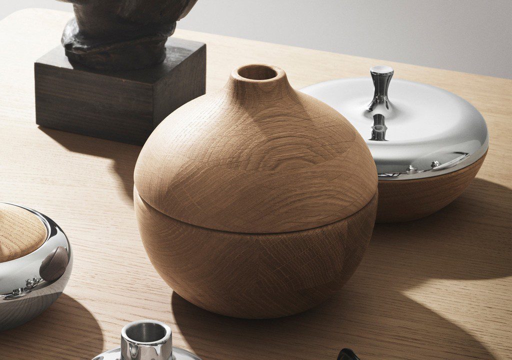 Wooden and metal containers on wooden table.