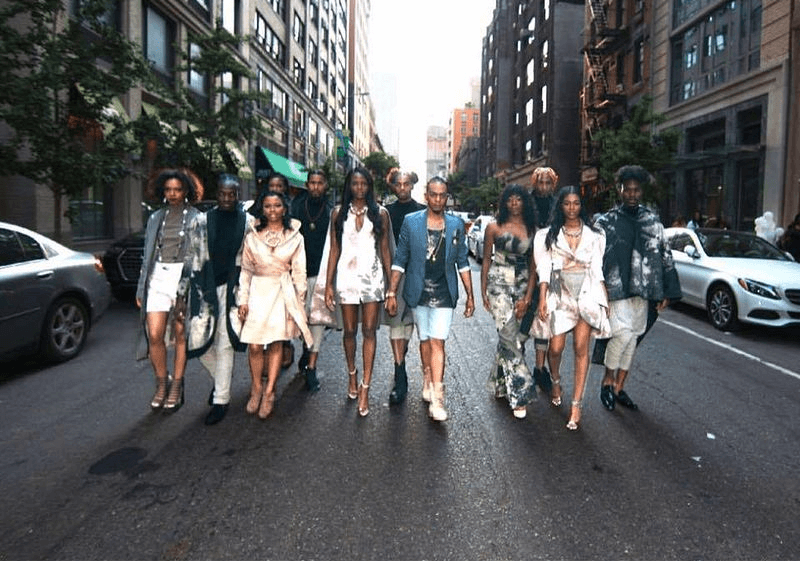 Fashionable group walking down city street.