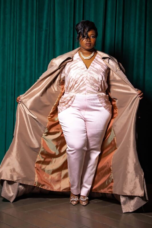Person in elegant outfit with open coat.