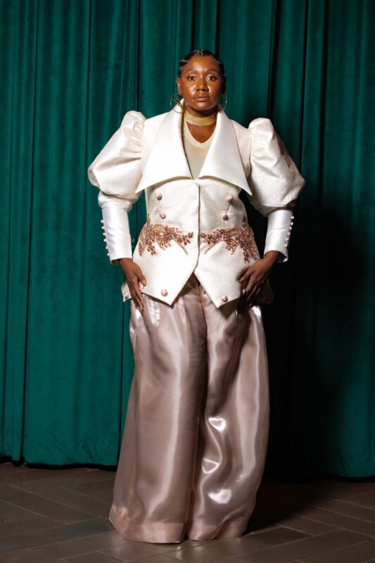 Person in elegant, avant-garde fashion outfit.