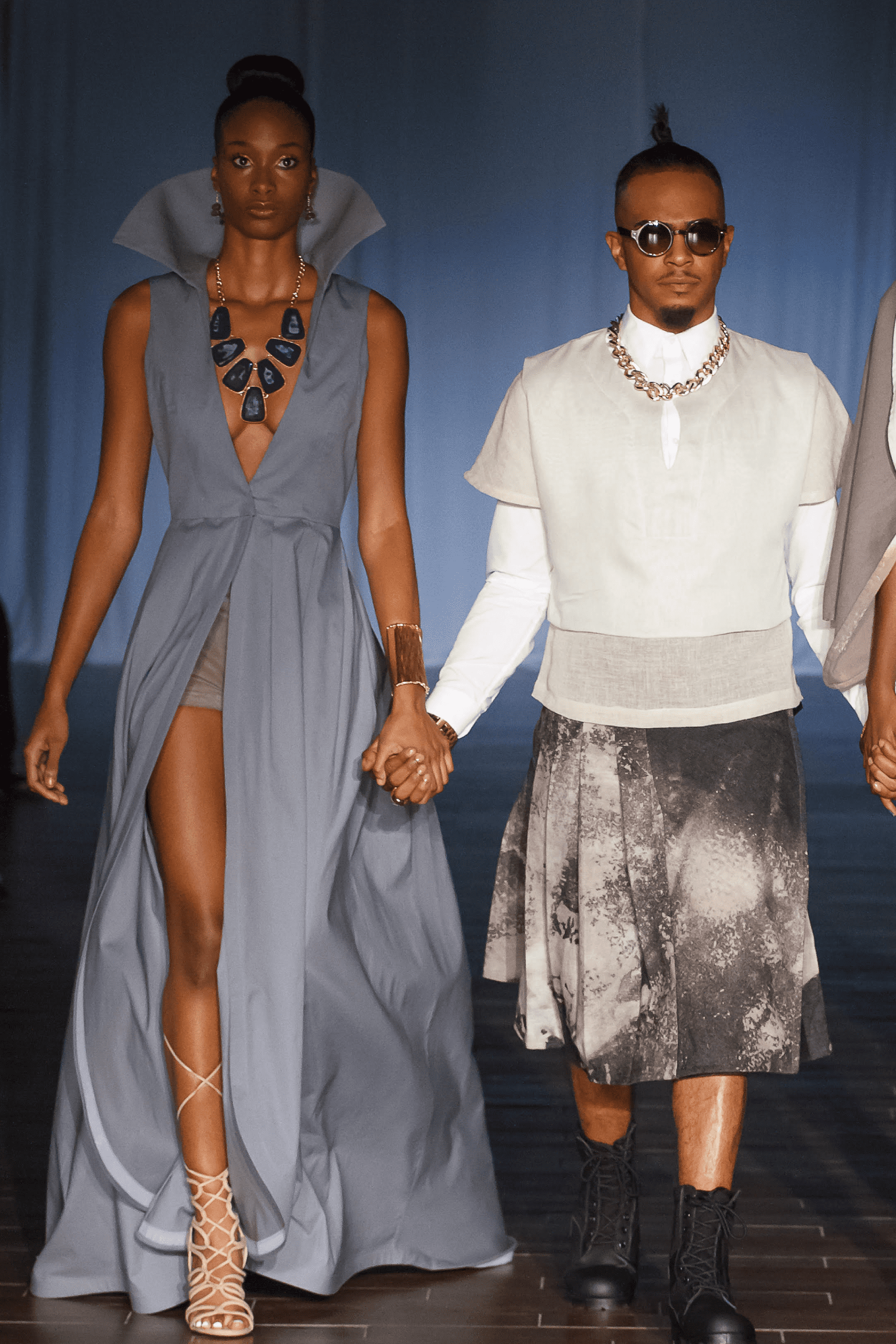 Models walking in stylish, modern fashion outfits.