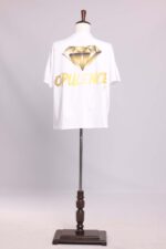 White t-shirt with gold diamond design.