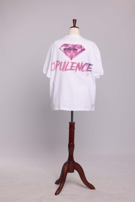 White T-shirt with pink diamond design.