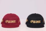 Red and black caps with "Opulence" embroidery.