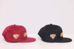 Red and black caps with gold embroidery.