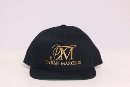 Black cap with gold "Tyran Marquis" logo.
