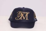 Navy cap with gold embroidered initials.