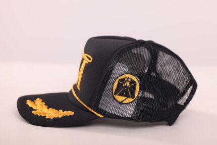 Black mesh cap with gold embroidery.