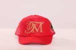 Red cap with gold embroidered initials.