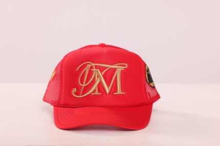 Red cap with gold embroidered initials.
