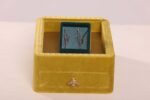 Yellow box with blue interior and emblem.
