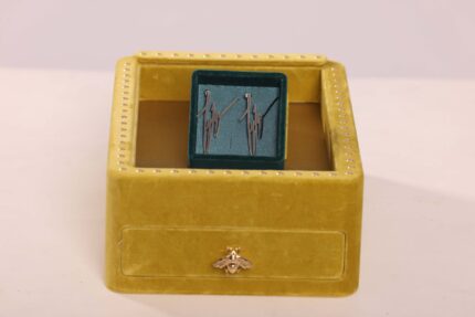 Yellow box with blue interior and emblem.
