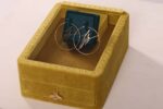 Hoop earrings in yellow velvet jewelry box.