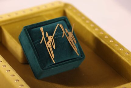 Gold cufflinks in green velvet box.