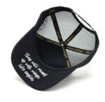 Black baseball cap with white embroidered text on the front.