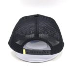 Back view of a black mesh baseball cap with adjustable strap.