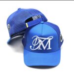 Blue baseball caps with a white stylized OM logo.